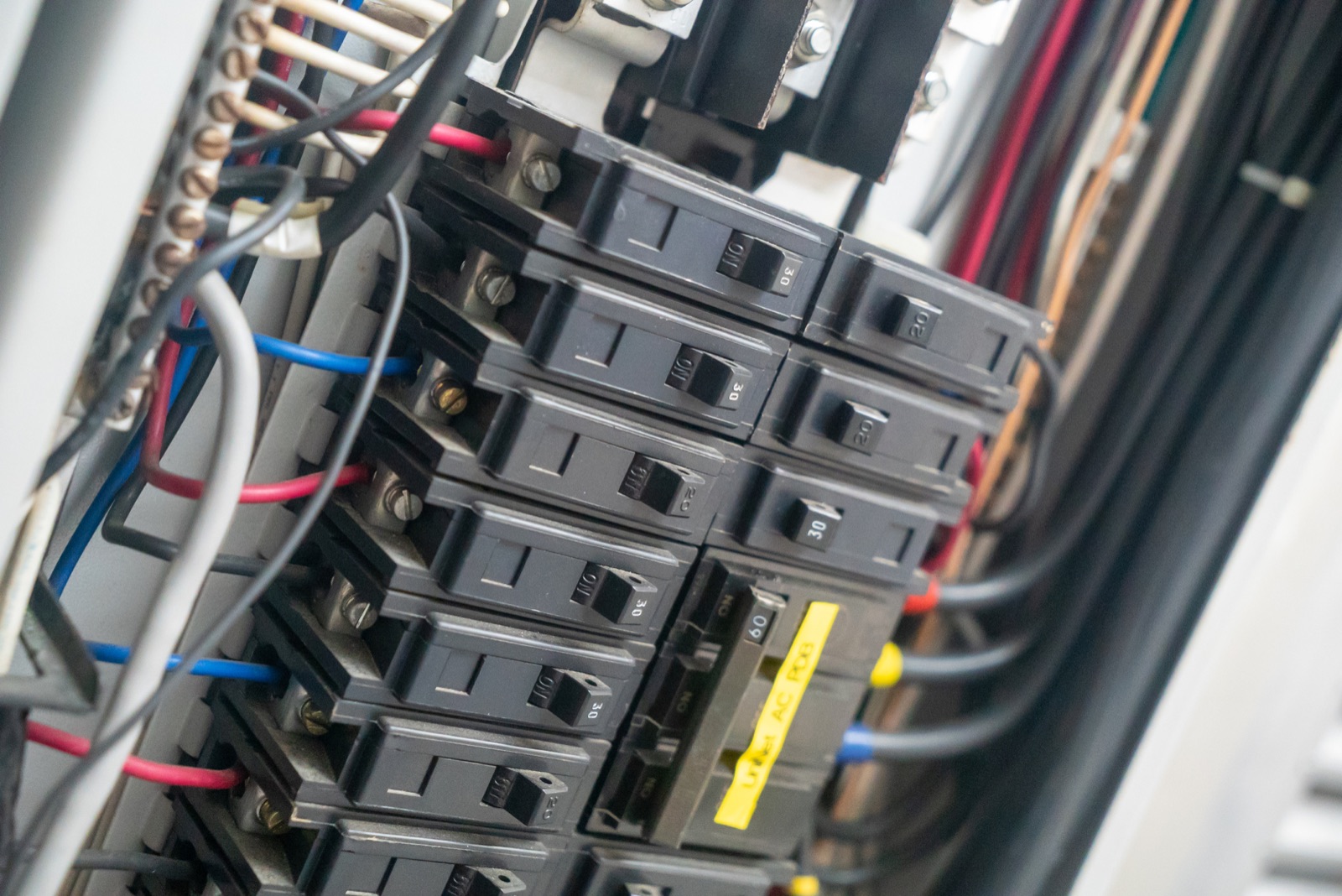 Close-up of circuit breakers and wiring inside a residential electrical panel in a Baltimore area home